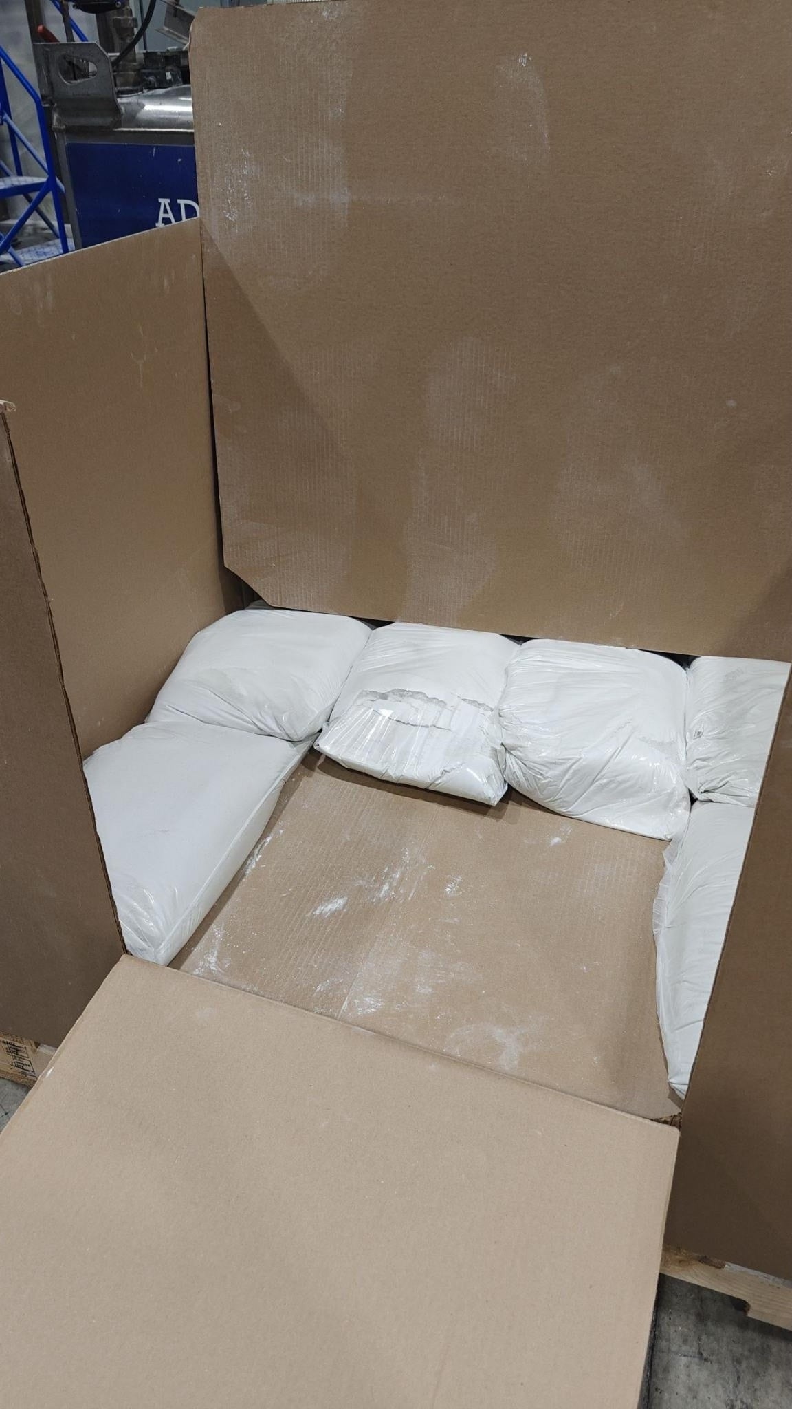 Cardboard box with white packages inside