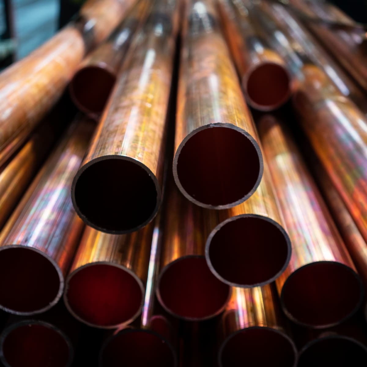 Stack of copper pipes with a close-up view