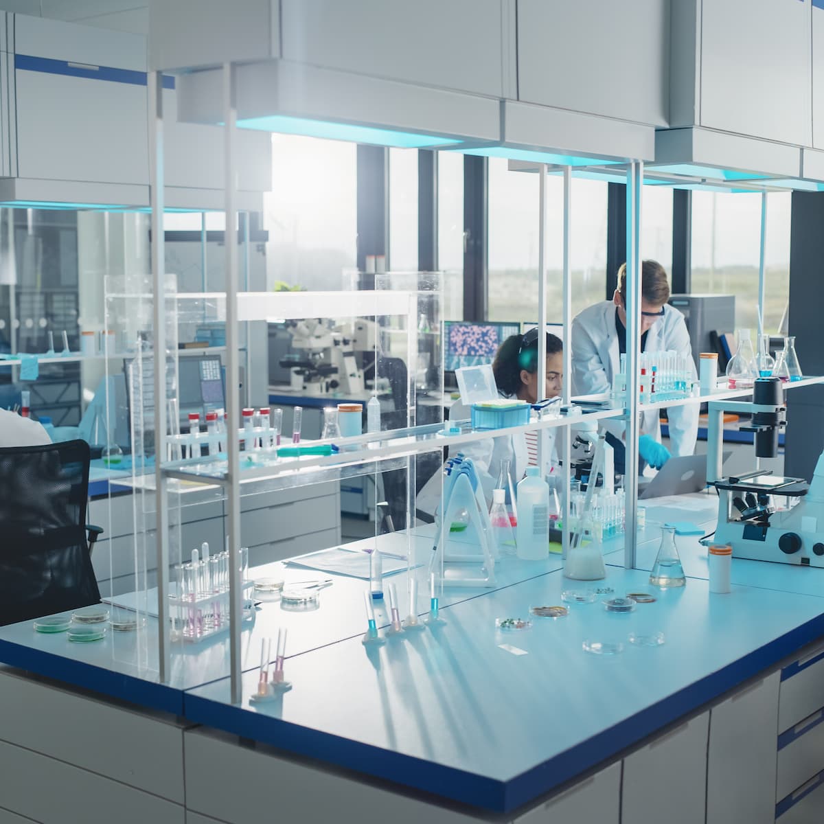 Modern laboratory with scientists working at their stations.