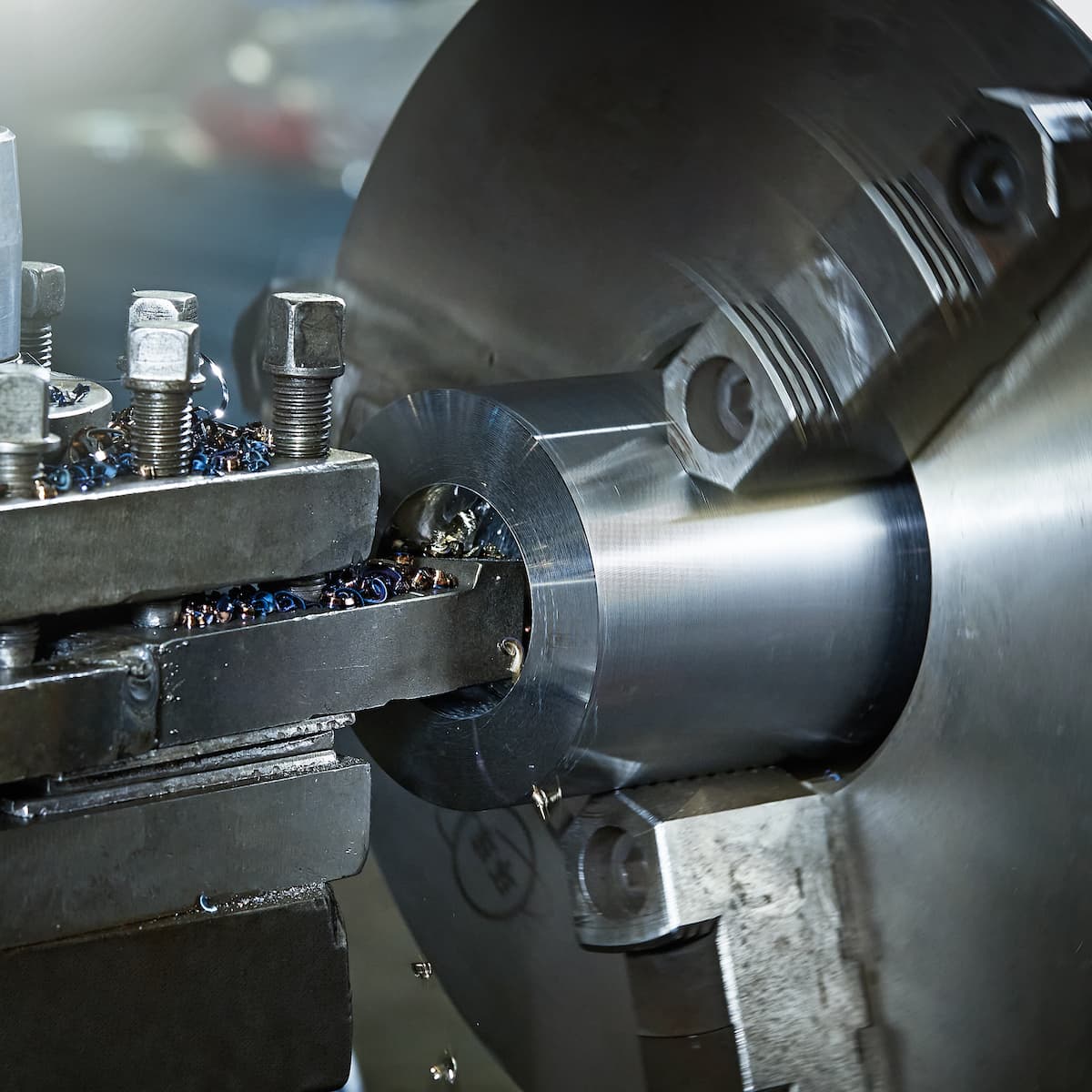Close-up of a metal lathe in operation with a focus on the machining process.
