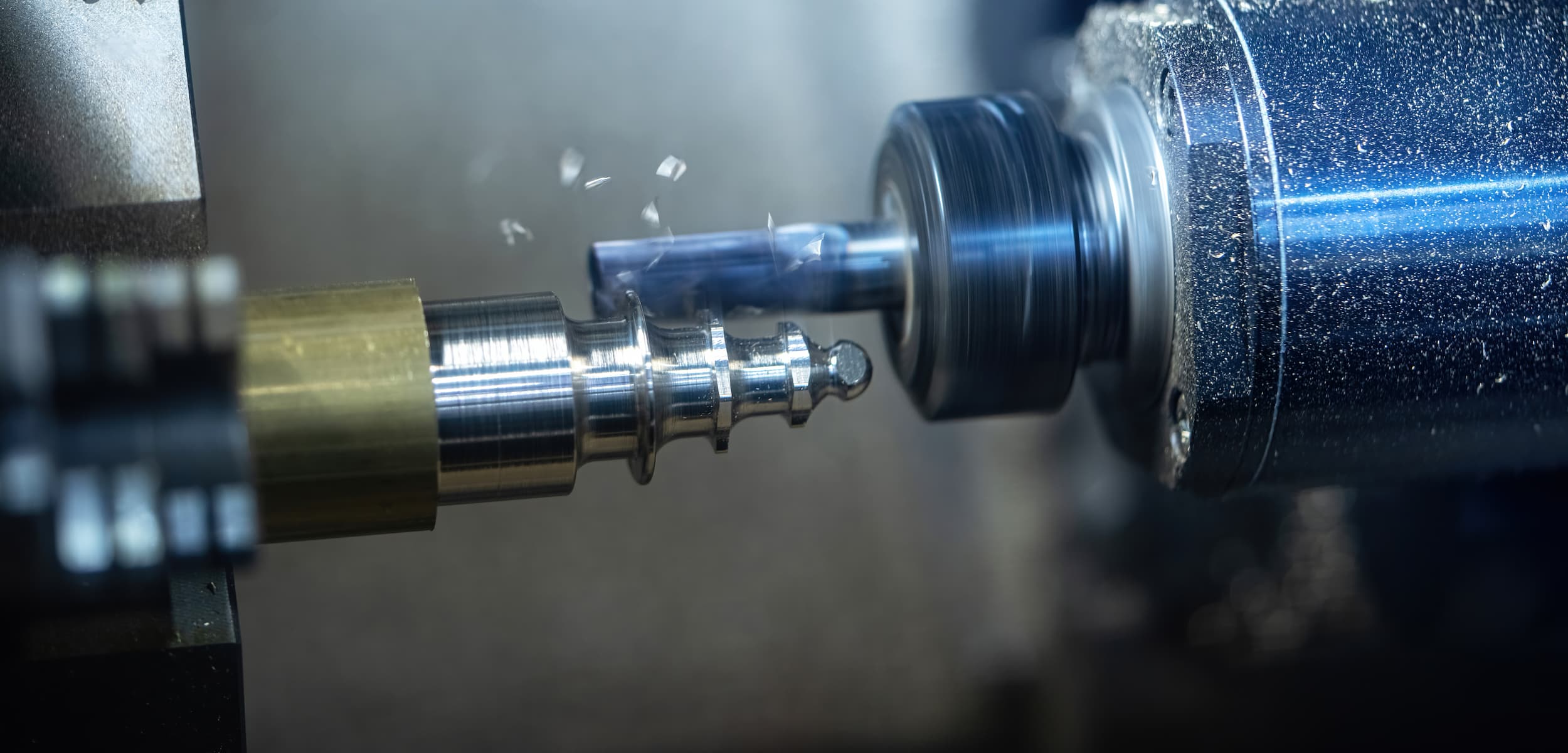 Close-up of a lathe machine in operation with metal components.