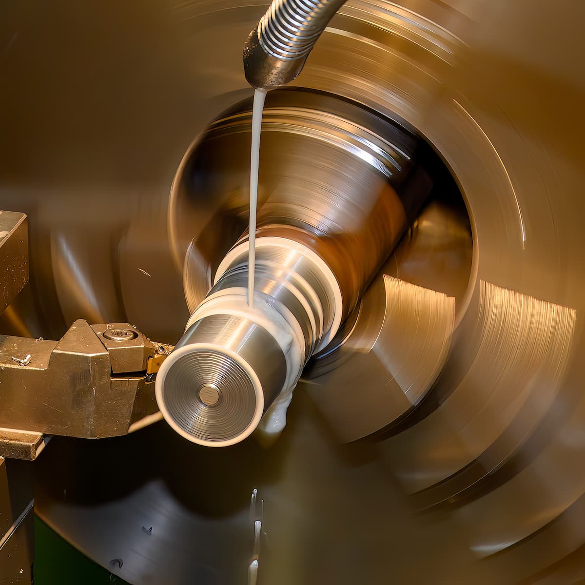 Metal lathe in operation with a metal piece being machined.