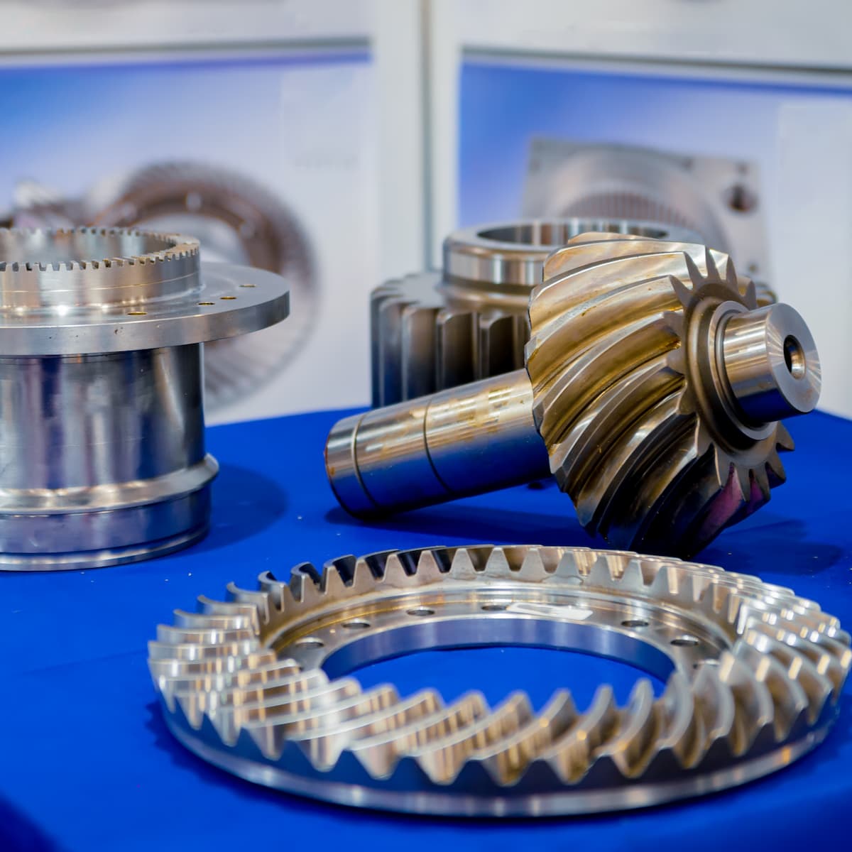 Metal gears on a blue surface with a blurred background