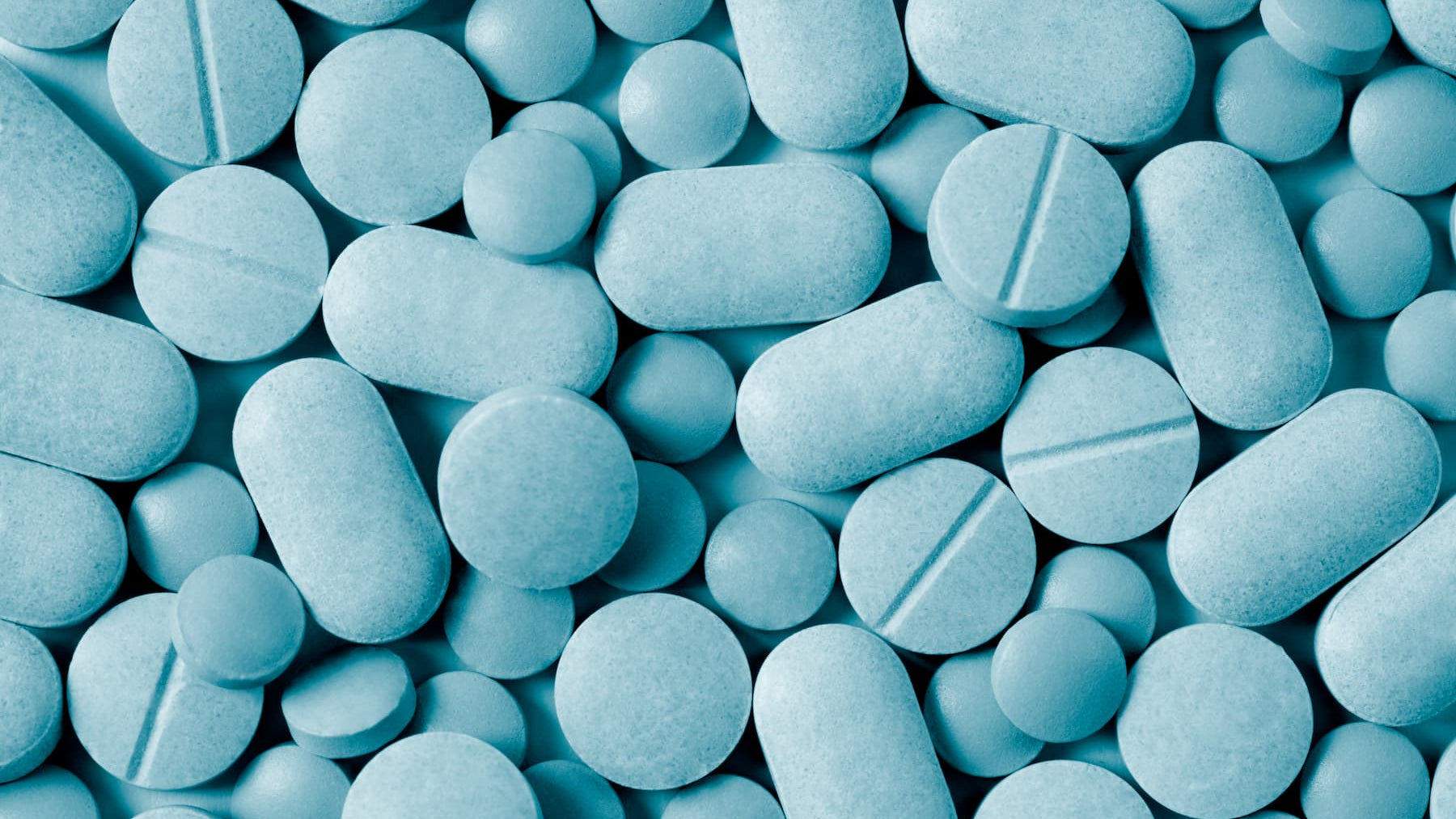 Close-up of blue pills and capsules