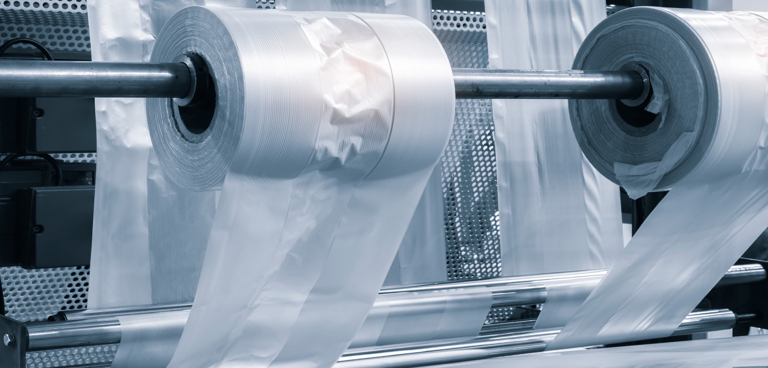Rolls of clear plastic sheeting on a machine