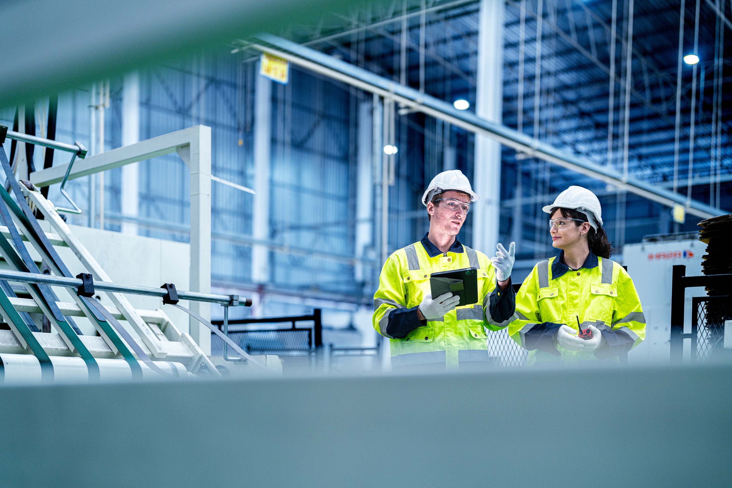 Two workers in manufacturing plant