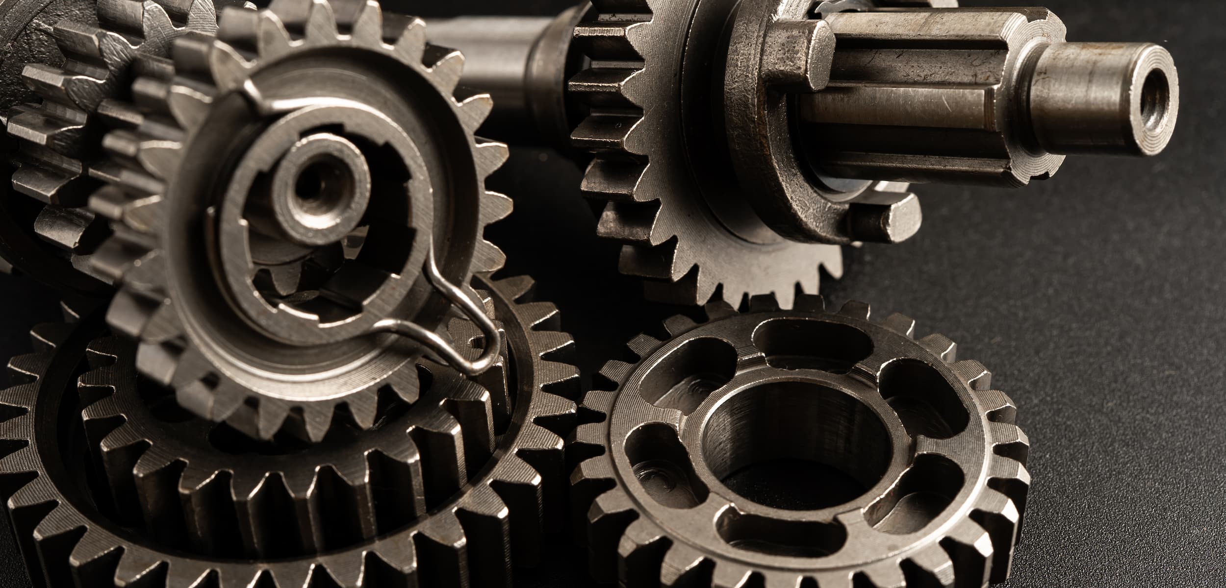 Close-up of metal gears on a dark background