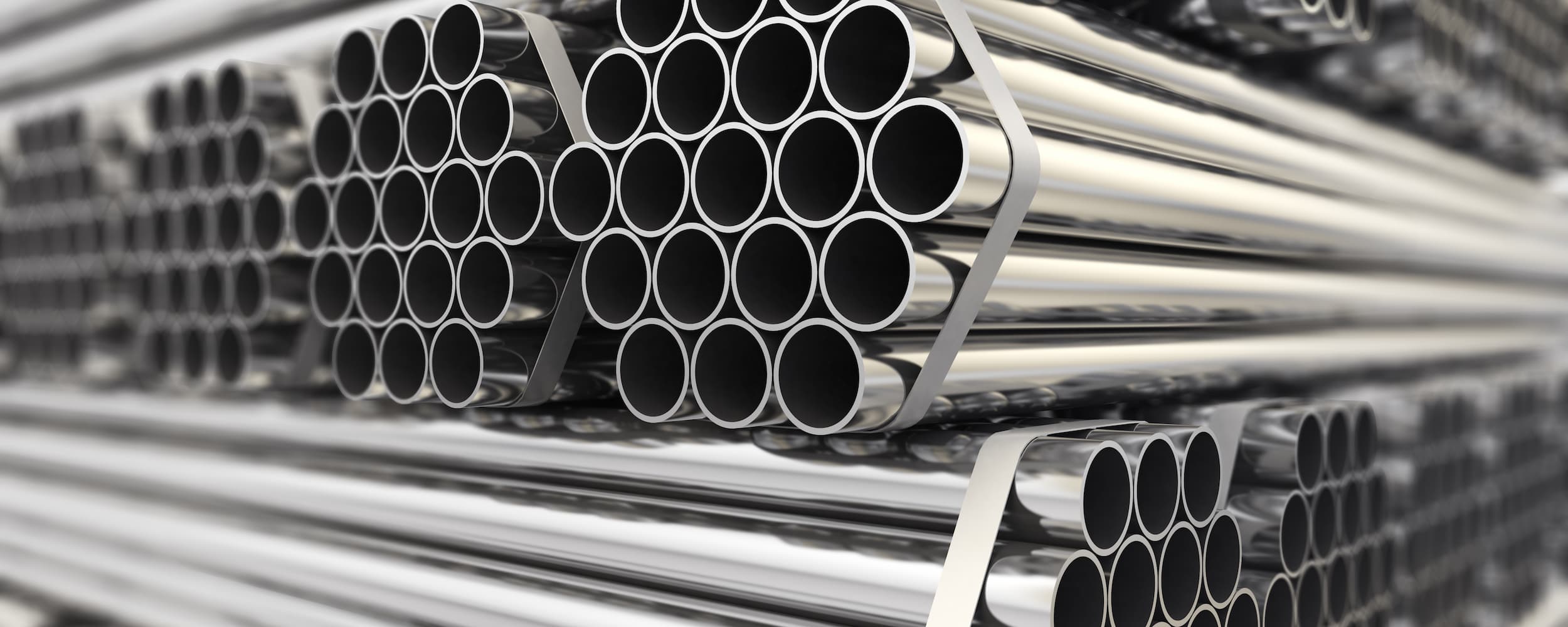Stack of metal pipes with a focus on the cylindrical shapes.