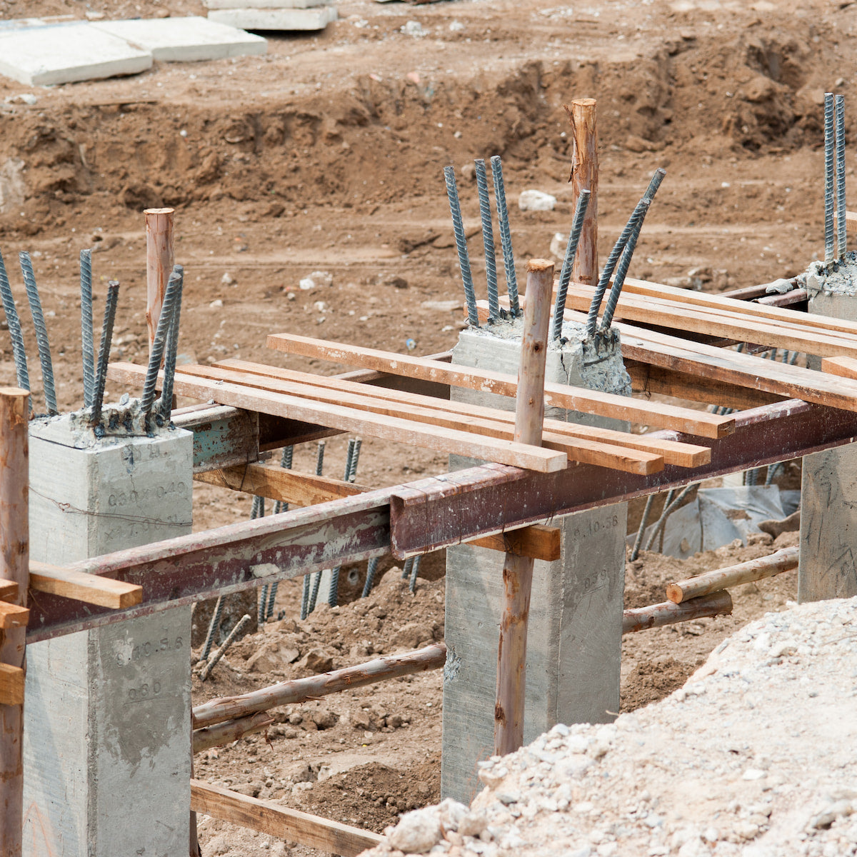 Construction site with wooden beams and concrete blocks