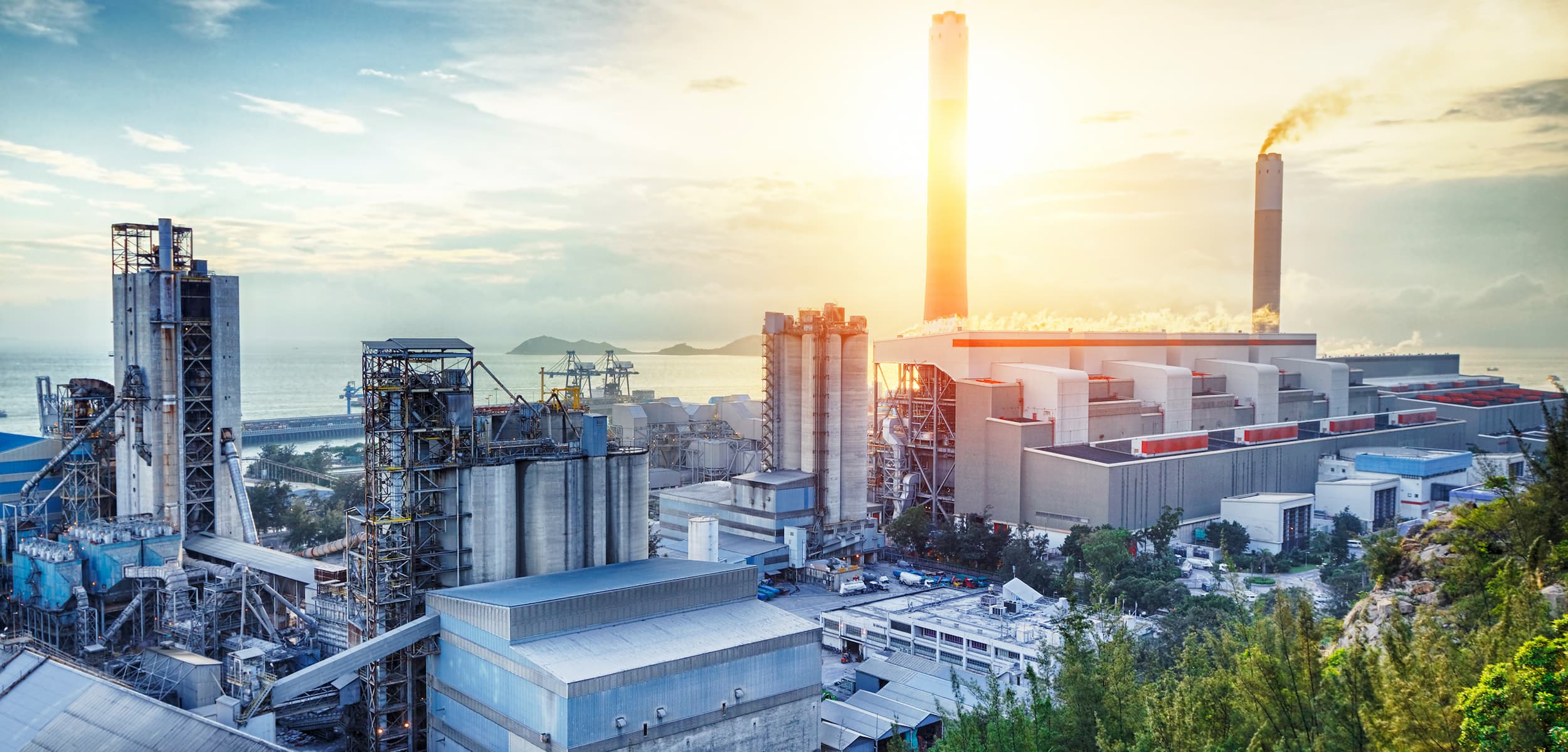 Industrial complex with multiple buildings and structures under a clear sky.