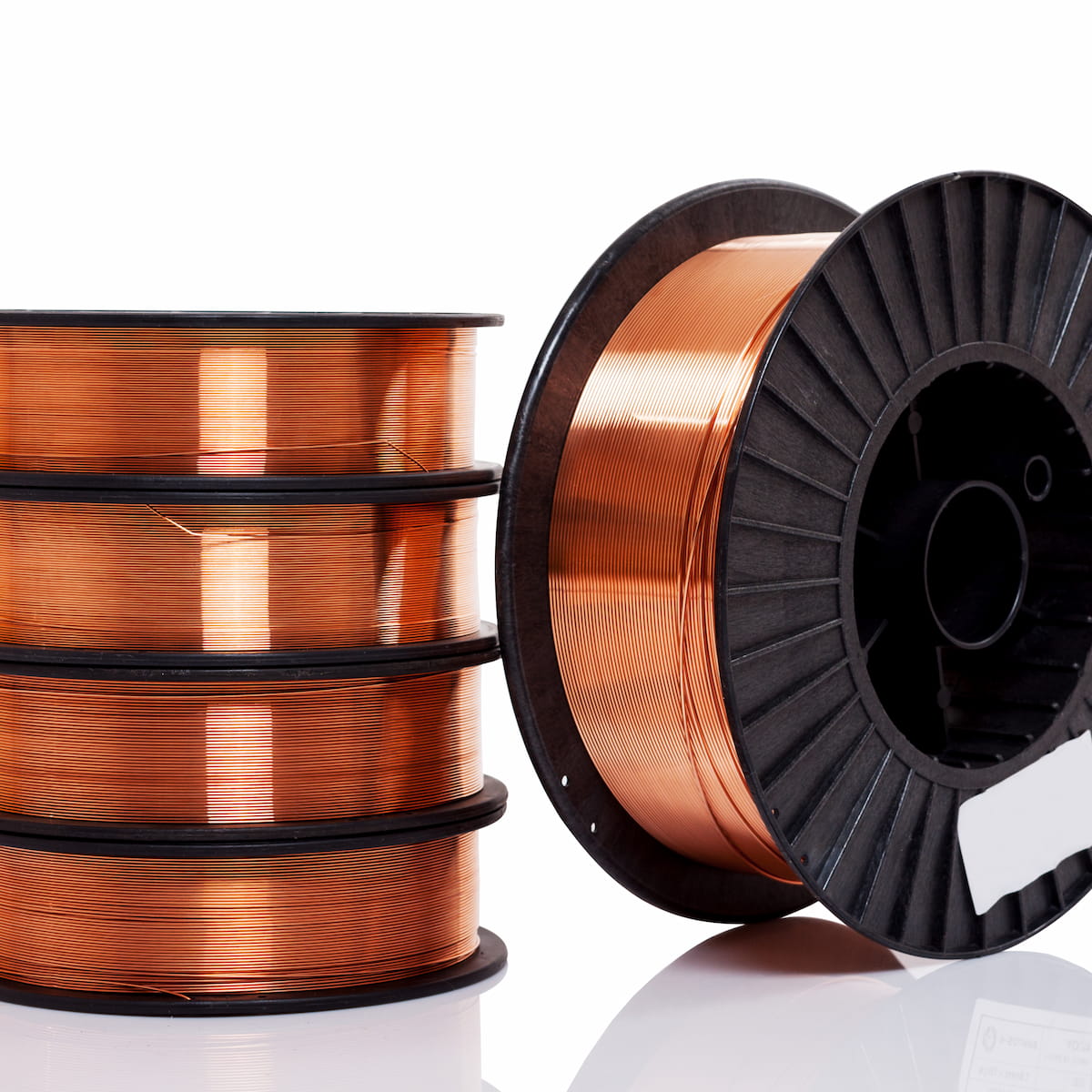 Spools of copper wire on a white background