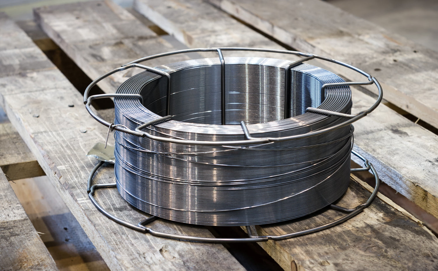 Roll of metal wire on a wooden surface