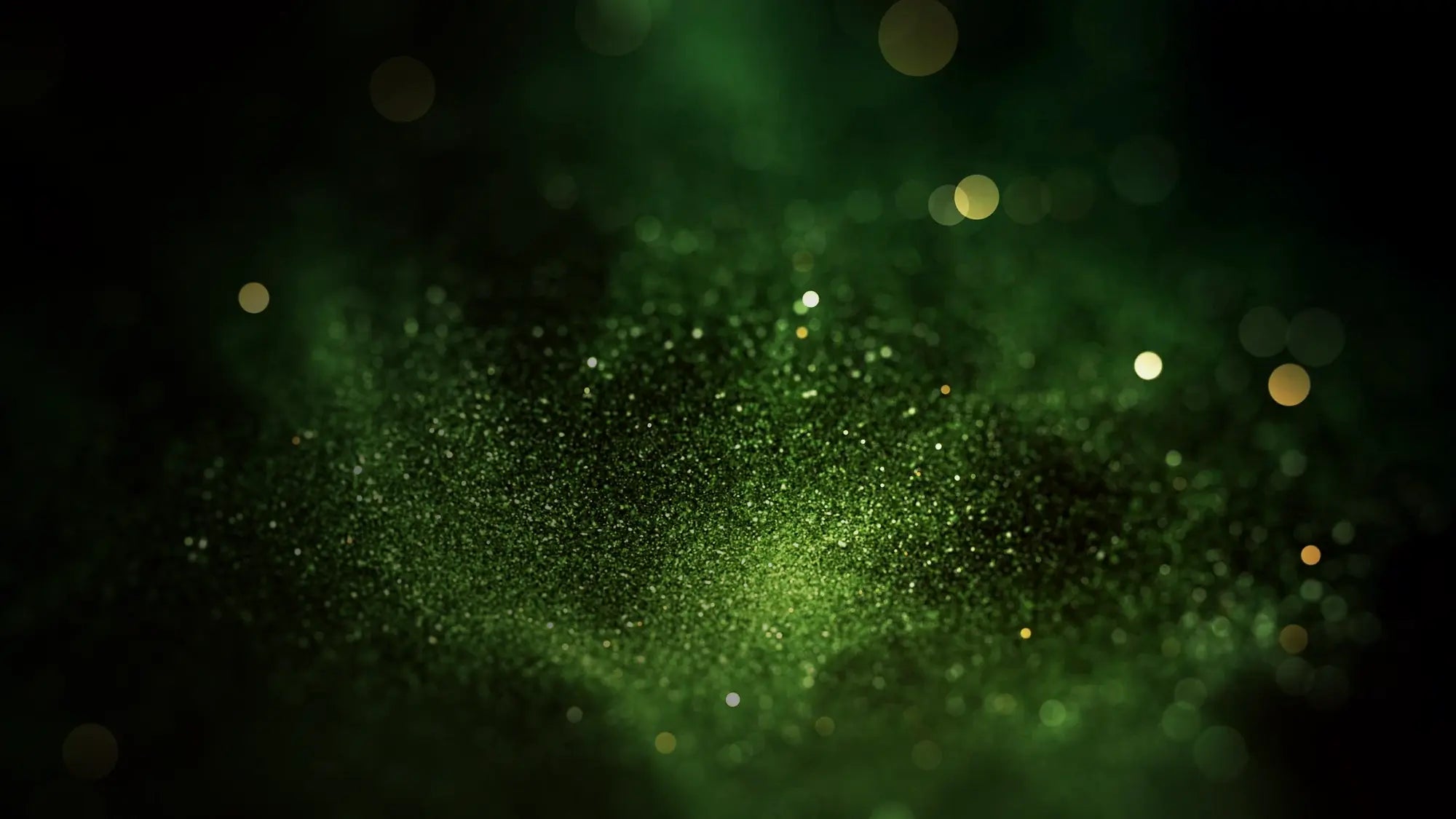 Green glittery particle effect on a dark background