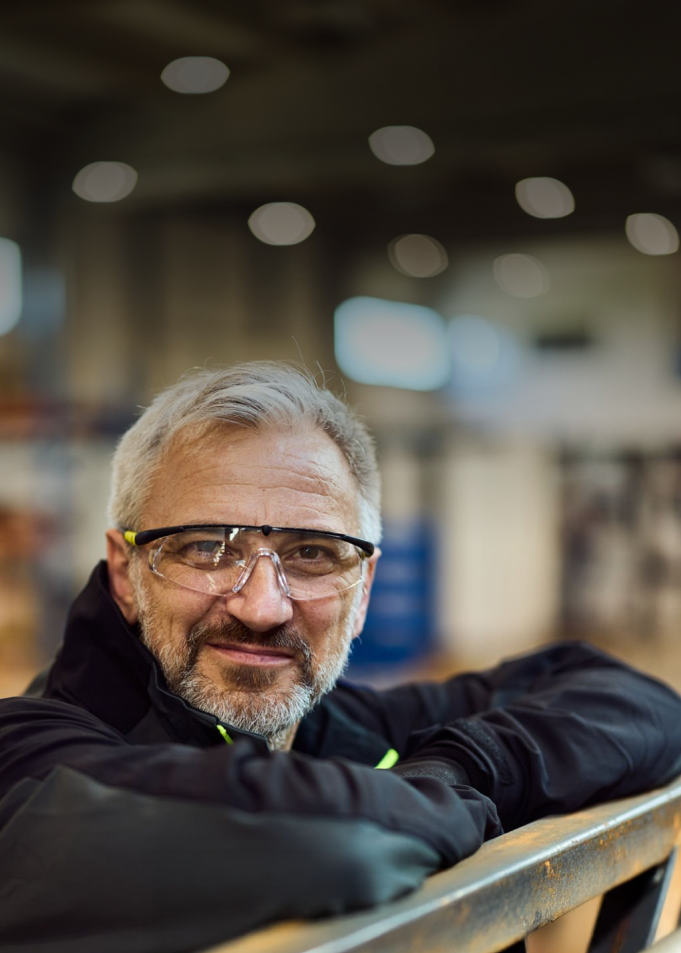 man in factory with safety goggles
